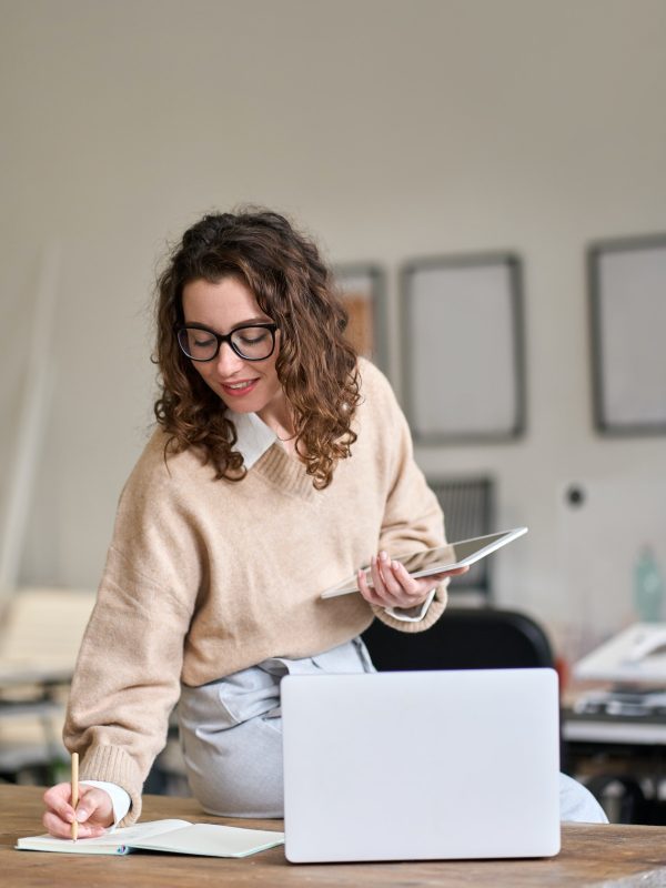 young-smiling-business-woman-working-in-office-using-digital-tablet-vertical-q33flycoe9s3js94otwk4sru2vw623a1r3lrfvy7gg